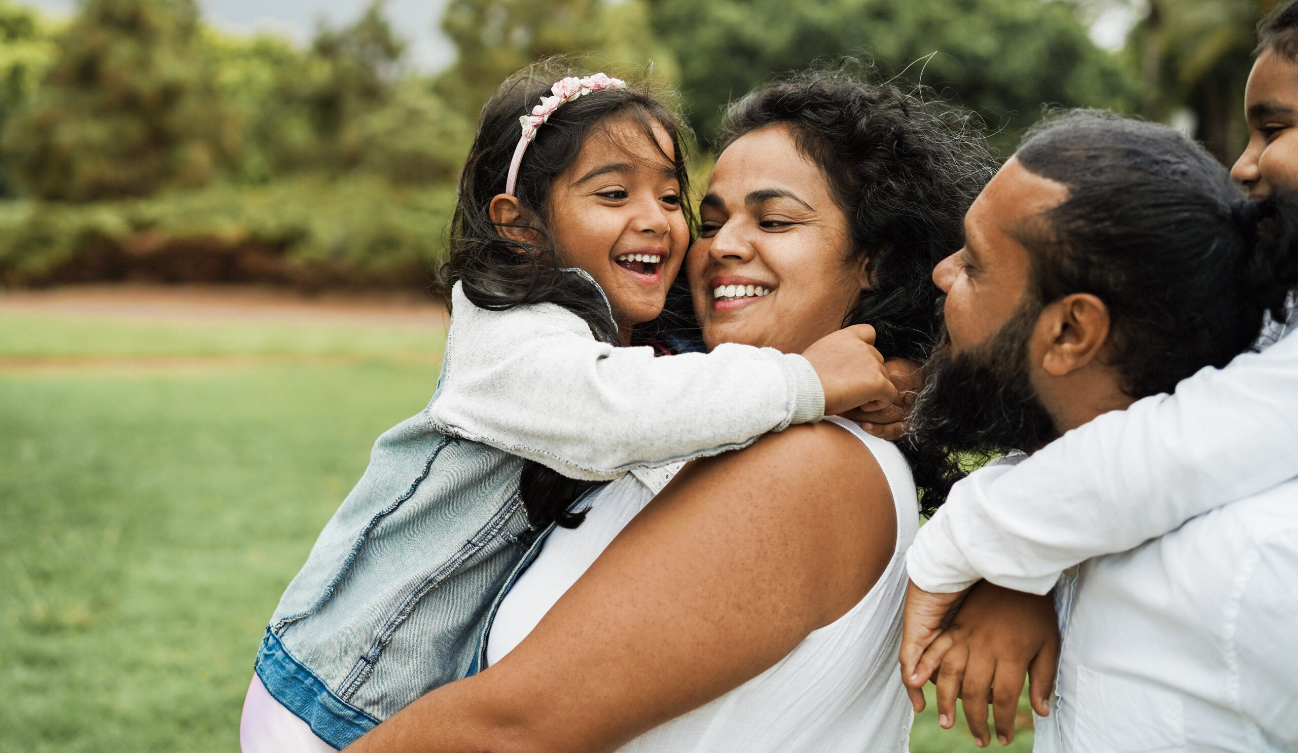 Happy indian family having fun outdoor - Hindu parents laughing Laughing family in texas