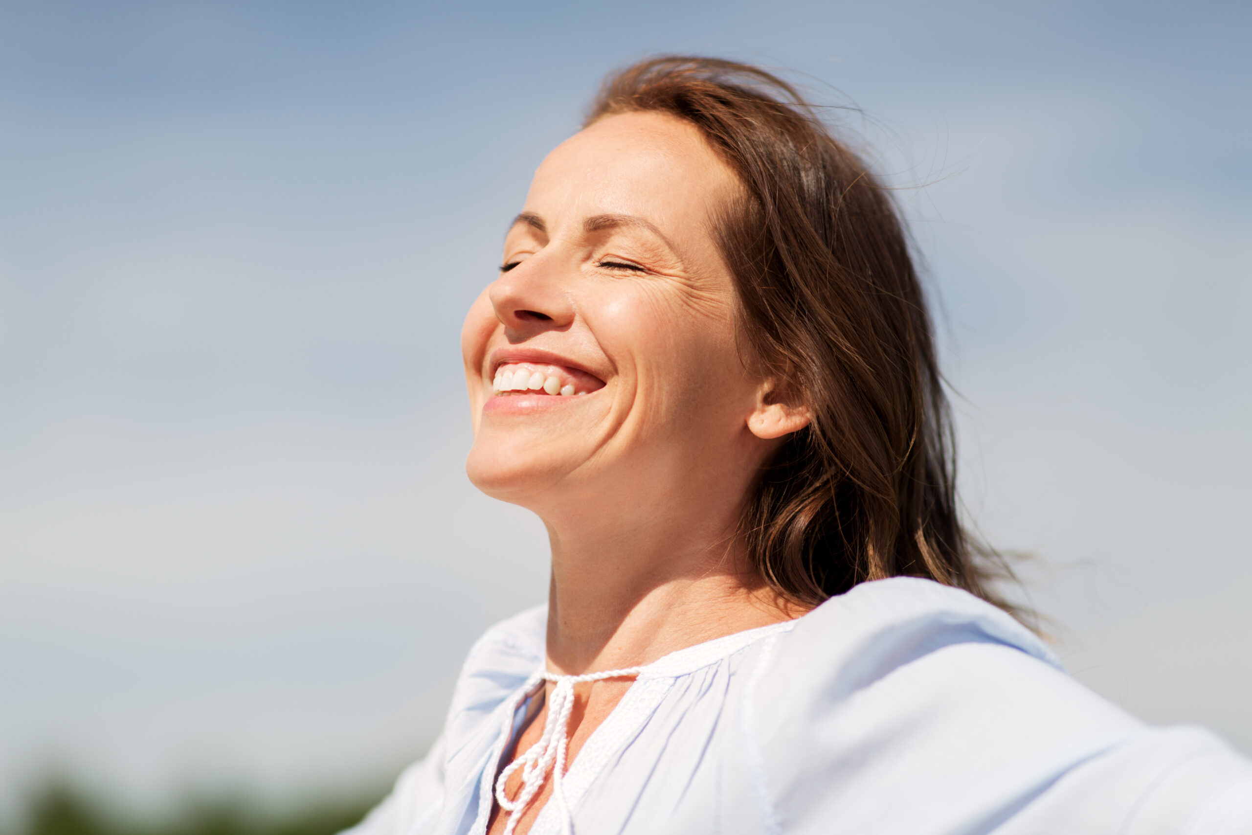 Woman with big smile enjoying the outdoors and sunshine in texas